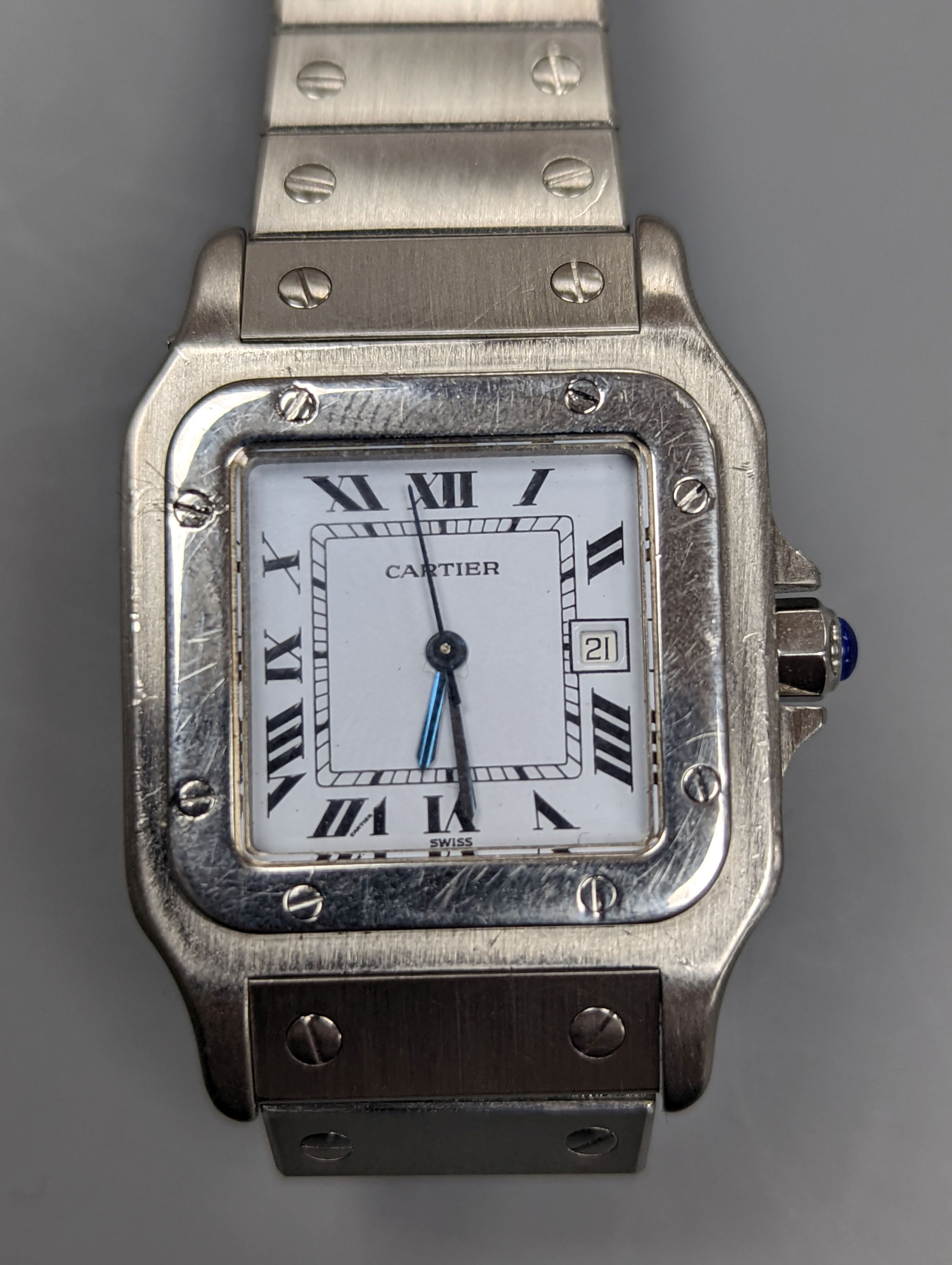 A gentleman's stainless steel Cartier Santos automatic wristwatch, on a stainless steel Cartier bracelet, no box or papers, cased diameter 30mm.